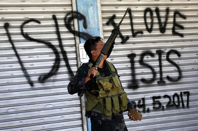 Displaced villagers attend a dawn mass in Marawi City
